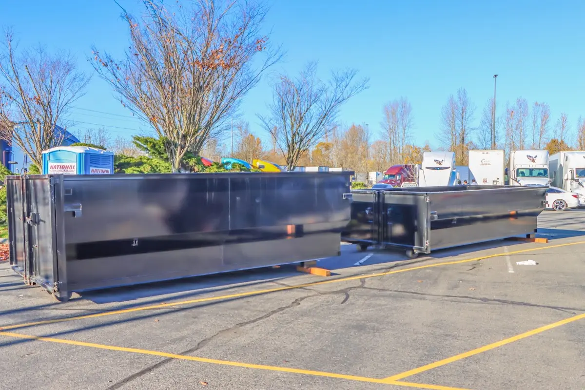 Professional dumpster rental service with roll-off container on residential driveway in Helena